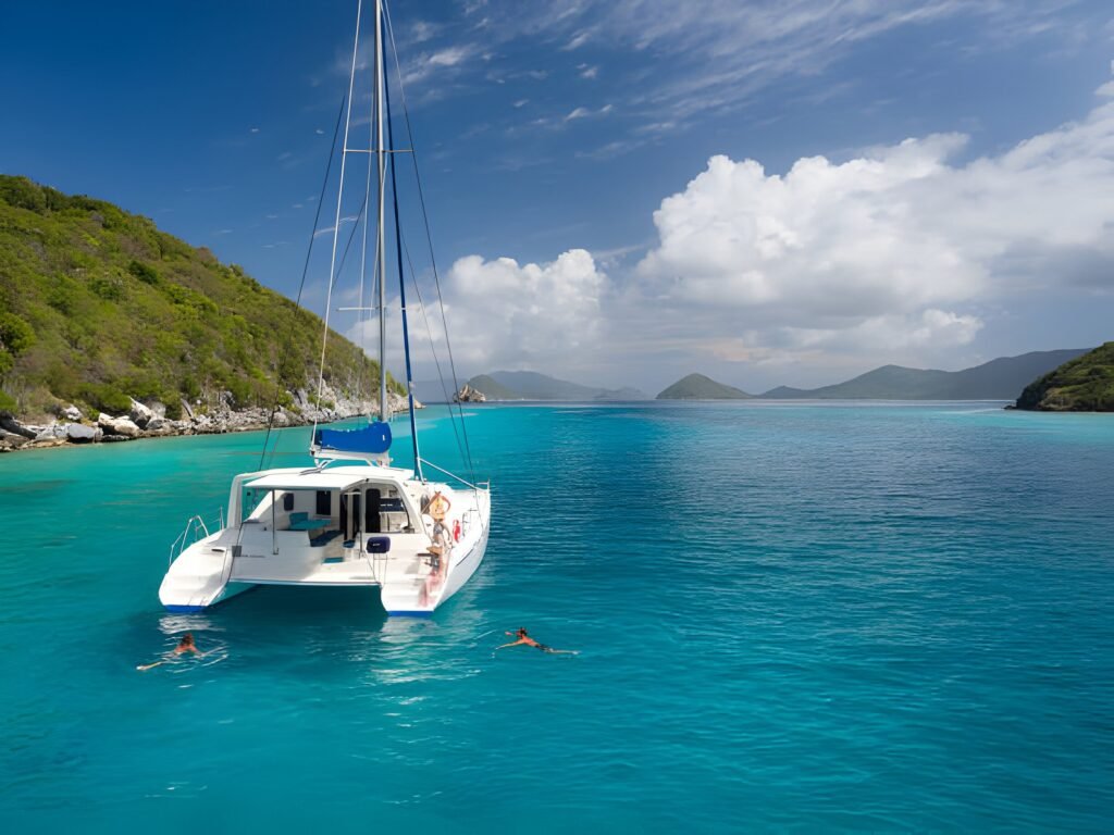 Sailing catamaran at anchor in clear water, like our catamaran charter on Amelia Island