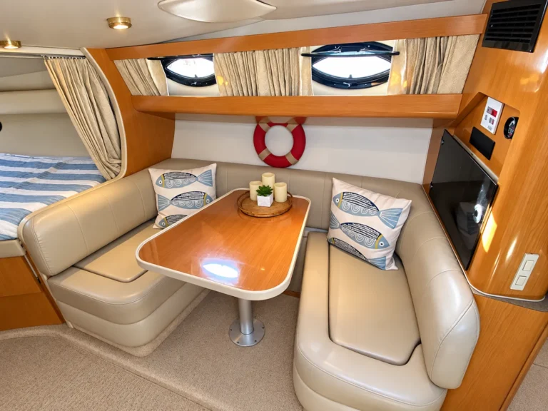 Cabin dinette with table and leather seating inside the 30-foot cruiser