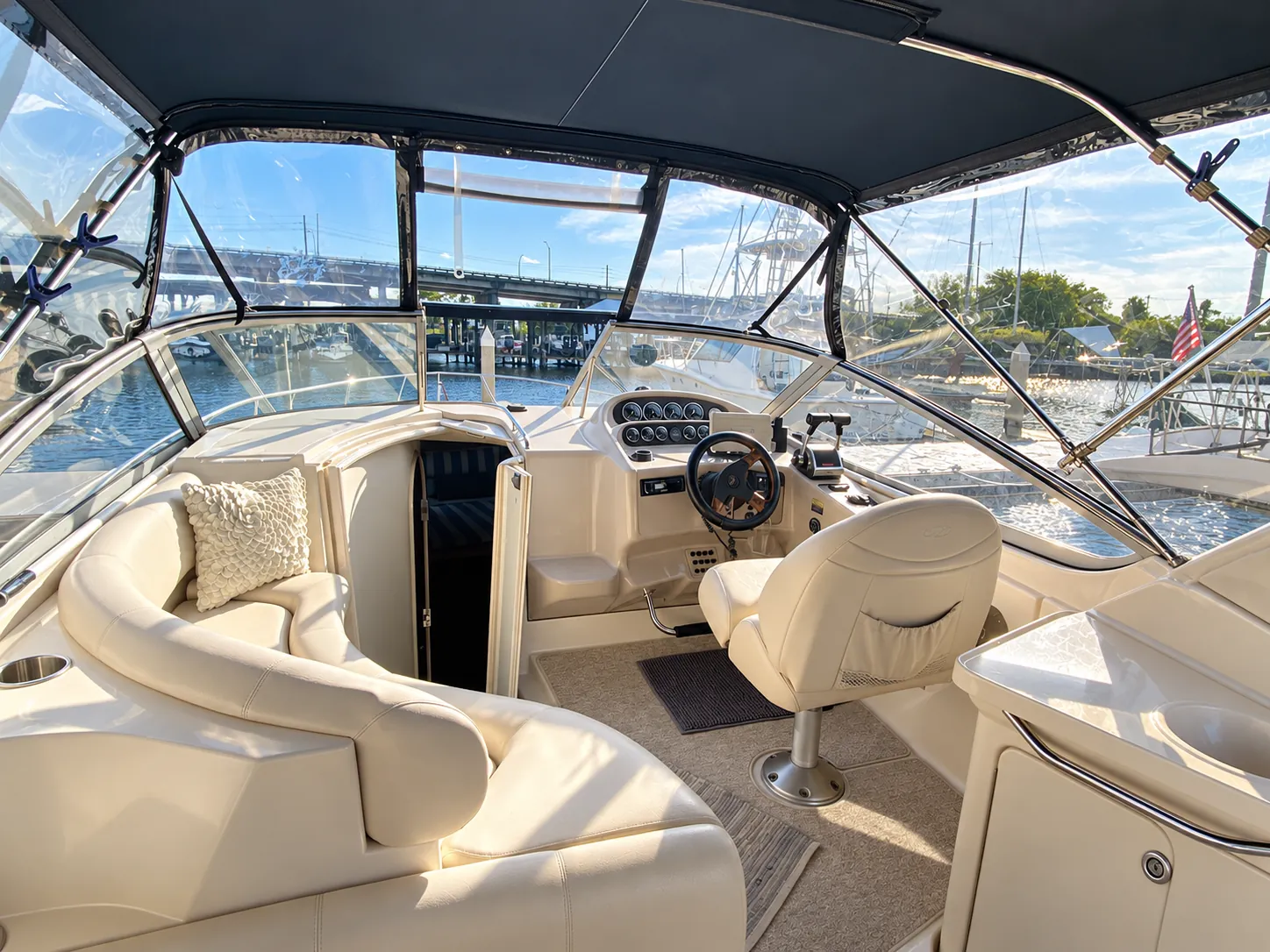 Cockpit of the 30-foot cruiser with helm seat and curved lounge seating