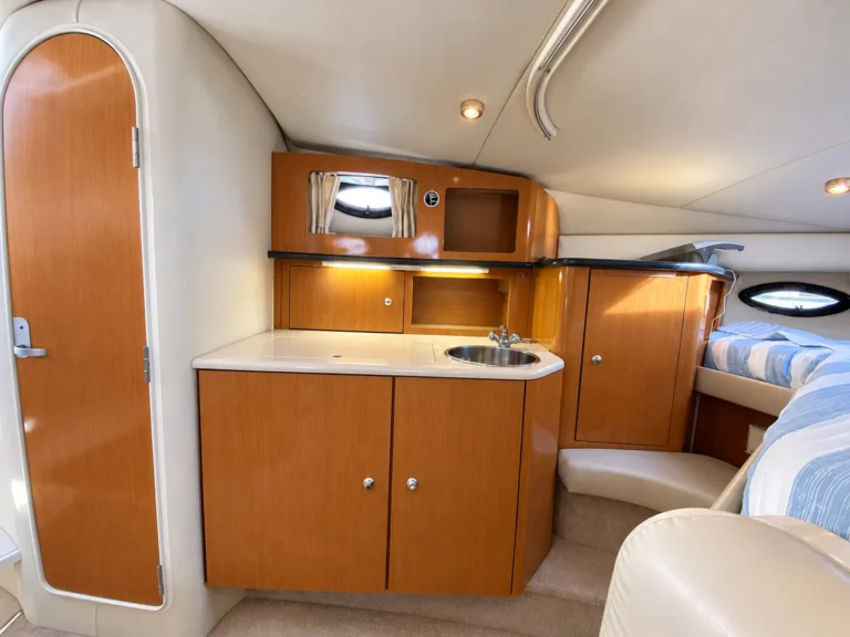 Galley with sink and wood cabinets inside the 30-foot cruiser
