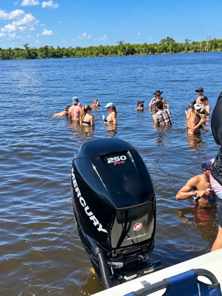 Guests swimming at a sandbar behind the 25-foot powerboat