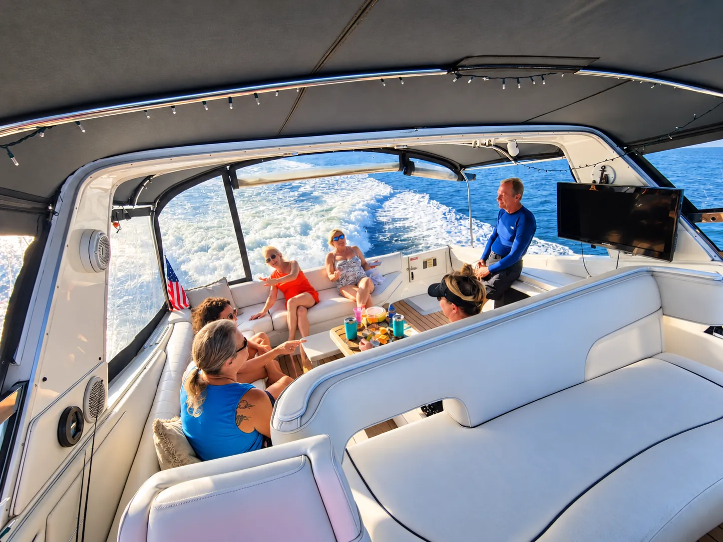 Guests enjoying the shaded cockpit lounge of the Sea Ray yacht while underway near Jacksonville
