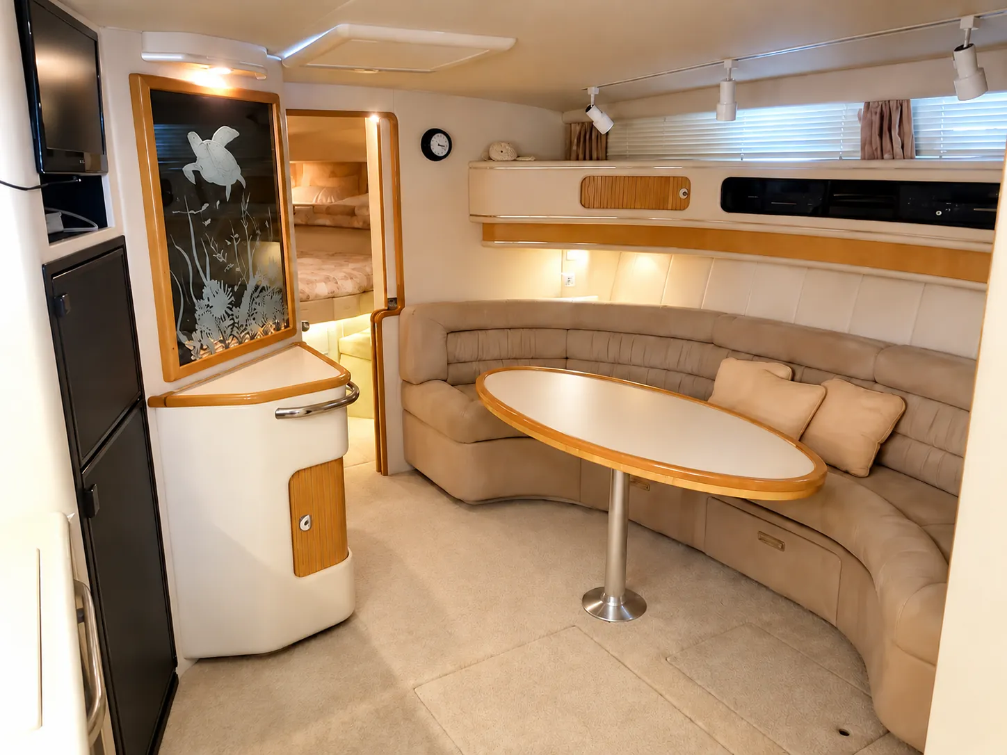Galley and dinette table inside the 44-foot Sea Ray yacht cabin