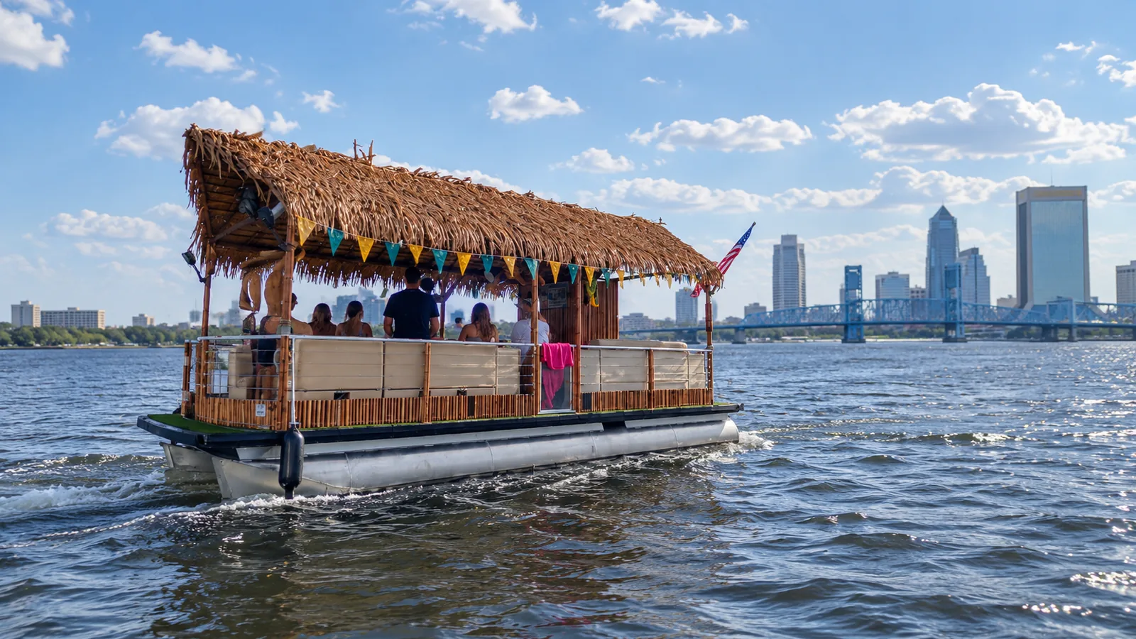Tiki boat with teal and gold flags cruising near downtown Jacksonville on game day