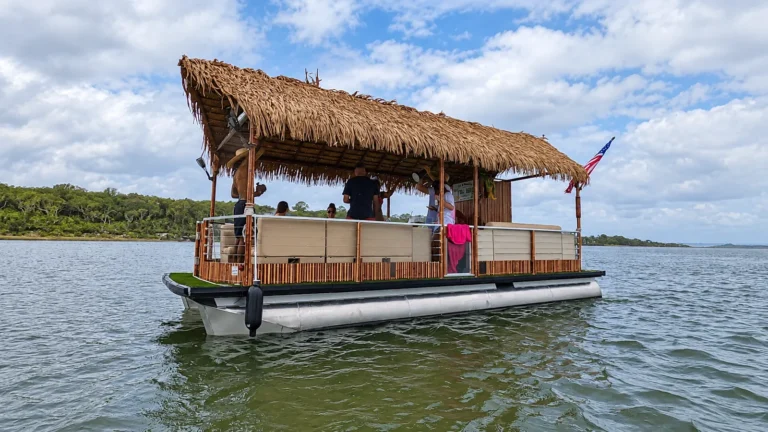Tiki hut pontoon boat cruising the water near Jacksonville